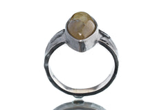 Front view of Labradorite oxidized silver ring showing hammered band texture and natural flashing gemstone centre.
