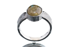 Front view of Labradorite oxidized silver ring showing hammered band texture and natural flashing gemstone centre.
