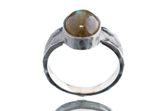 Front view of circular Labradorite ring showing U-shaped oxidized silver band and sculptural oculus setting.