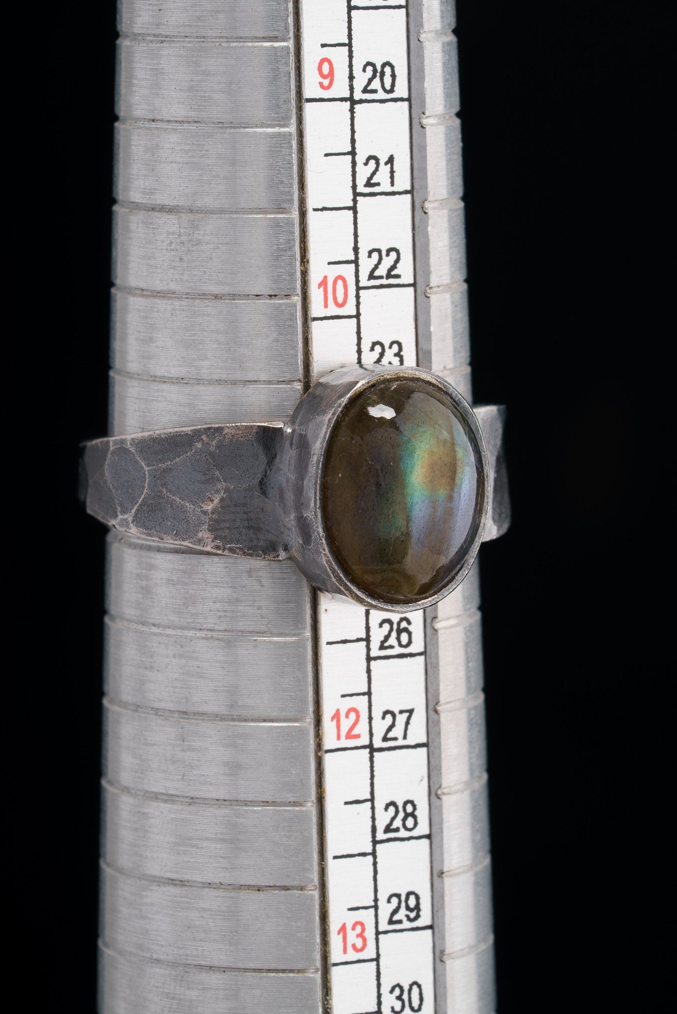 Mystic Oculus Labradorite ring shown beside a ruler for scale, with oxidized 925 sterling silver and circular gemstone.