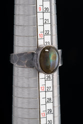 Mystic Oculus Labradorite ring shown beside a ruler for scale, with oxidized 925 sterling silver and circular gemstone.