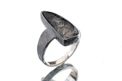 Rutilated Quartz ring in oxidized 925 sterling silver with hammered texture, open-back bezel, and visible rutile strands.
