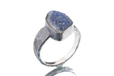 Dumortierite ring in oxidized 925 sterling silver with hammered texture, open-back bezel, and deep blue gemstone.