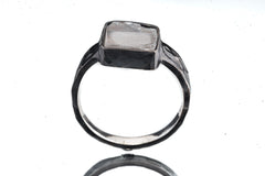 Front view of Selenite ring showing pale gypsum stone in dark oxidized sterling silver with open-back construction.