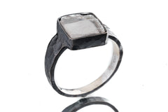 Selenite ring shown from the side with hammered oxidized silver, raised bezel setting, and polished highlights.