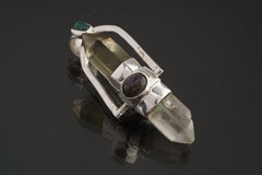 Two Sided Crystal Spinner Pendant shown angled on black background with Citrine, Chlorite Quartz, Apatite, Labradorite, and Opal details.