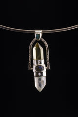 Two Sided Crystal Spinner Pendant shown on black background with clear crystal point, silver bearing, and black cotton necklace.