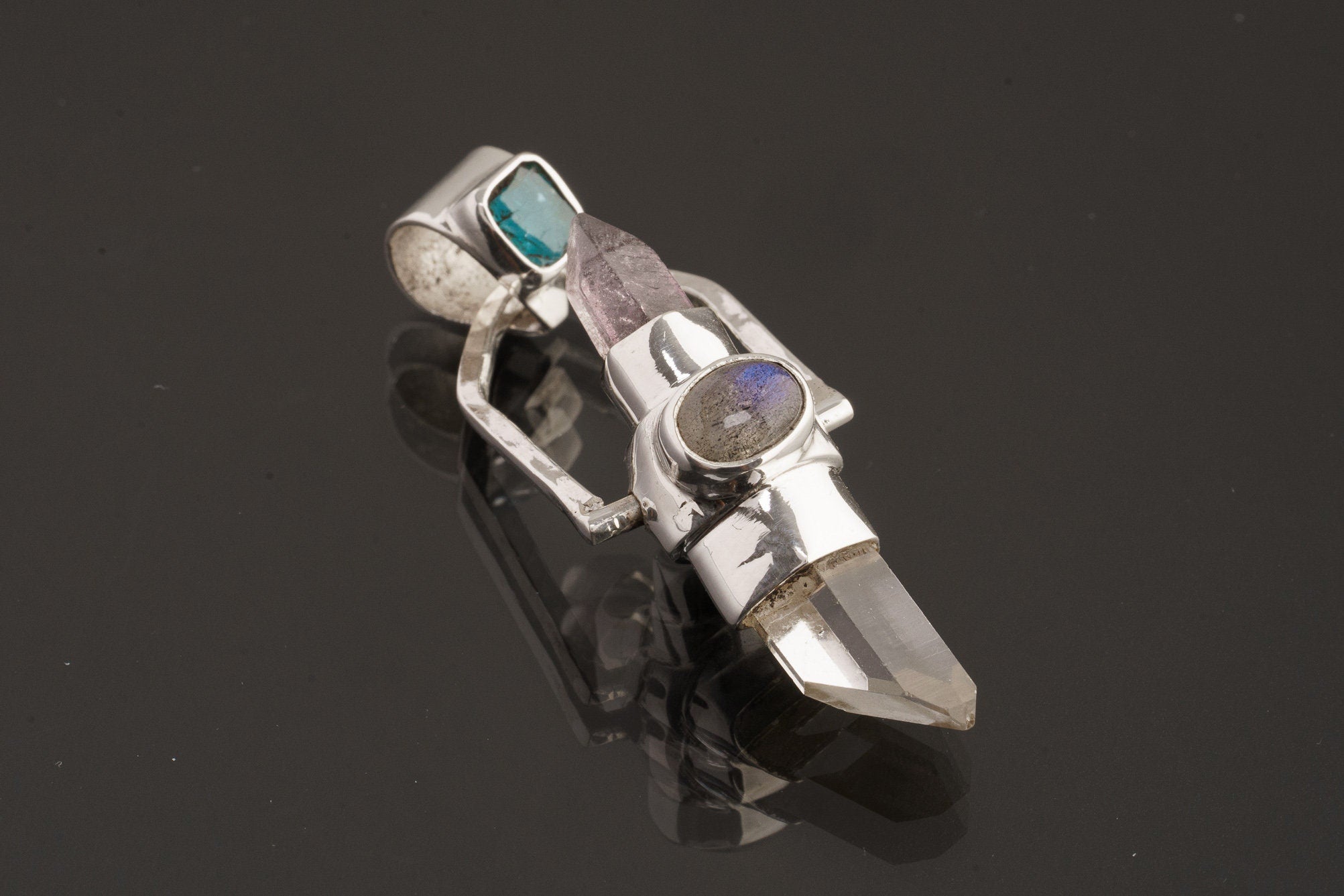 Two Sided Crystal Spinner Pendant shown on black background with high-polish sterling silver and mixed gemstone construction.