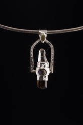 Two Sided Crystal Spinner Pendant shown on black background with high-polish sterling silver and mixed gemstone construction.