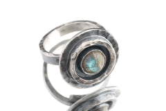 Old World Labradorite Adjustable Ring shown on white background with circular silver setting and blue-gold Labradorite flash.