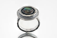 Old World Labradorite Adjustable Ring shown from the front with multi-layered bezel and rustic hammered sterling silver.