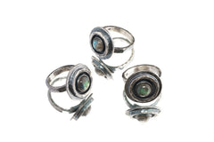 Group of Old World Labradorite Adjustable Rings shown on white background with sturdy textured silver bands.
