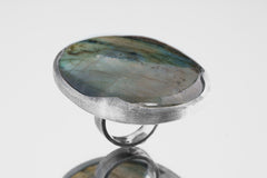 Side view of XXL Labradorite statement ring showing thick sterling silver setting and large blue-green flashing stone.