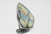 XXL Labradorite adjustable ring in shiny 925 sterling silver with large flashing stone and thick waved bezel setting.