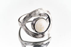 Pearl adjustable loop ring in textured 925 sterling silver shown close-up on a white background with soft organic lustre.
