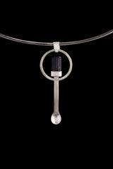 Black Tourmaline spoon pendant shown on a silver choker with hammered 925 sterling silver and dark stone setting.