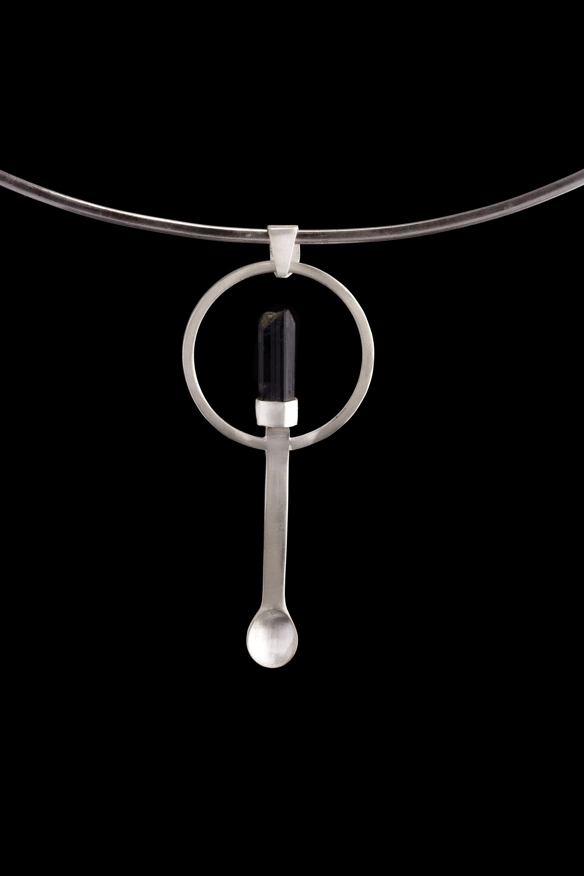 Black Tourmaline ritual spoon pendant shown on a silver choker with solid 925 sterling silver and dark stone detail.