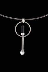Black Tourmaline ritual spoon pendant shown on a silver choker with solid 925 sterling silver and dark stone detail.
