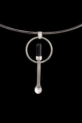 Black Tourmaline ritual spoon pendant shown on a silver choker with solid 925 sterling silver and dark stone detail.