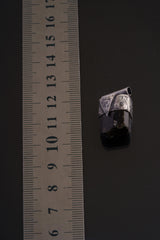Himalayan Dravite Tourmaline Stack Pendant shown beside a ruler for scale with oxidized silver cap and dark terminated stone.