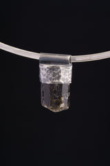 Himalayan Dravite Tourmaline Stack Pendant shown on black background with compact dark crystal body and textured silver cap.