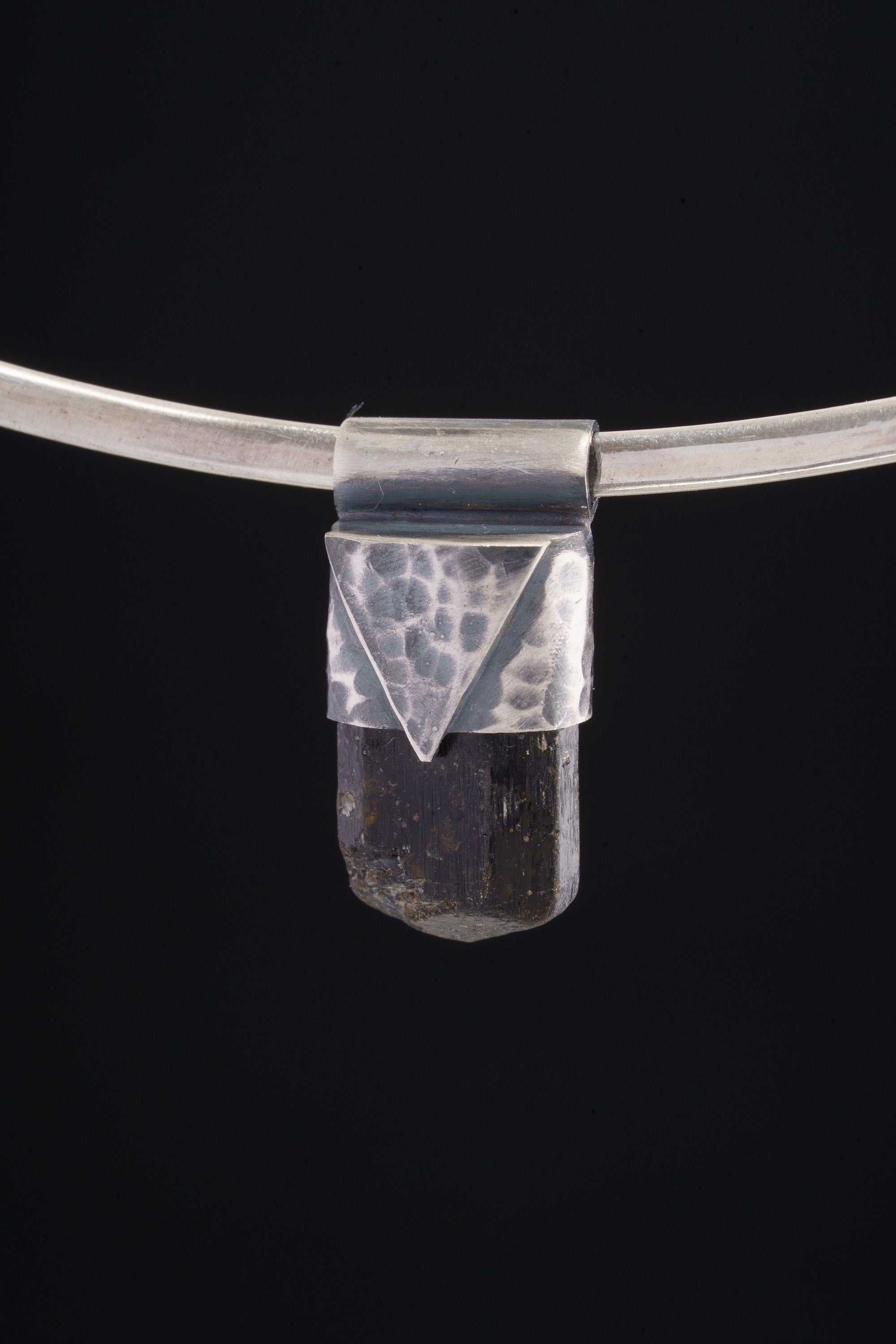 Himalayan Dravite Tourmaline Stack Pendant shown on black background with silver choker and compact smoky crystal body.