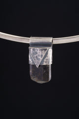 Himalayan Dravite Tourmaline Stack Pendant shown on black background with silver choker and compact smoky crystal body.