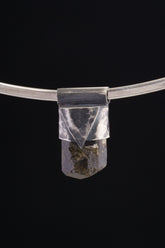 Himalayan Dravite Tourmaline Stack Pendant shown on black background with oxidized sterling silver cap and dark terminated crystal.