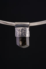 Himalayan Dravite Tourmaline Stack Pendant shown worn on black background with compact dark crystal body.