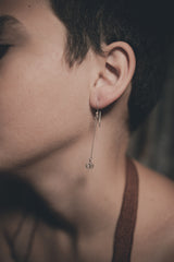 Herkimer Diamond Quartz dangle earrings shown worn on a model, with fine sterling silver hooks and small crystal drops.