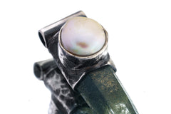 Close-up of old South Sea Pearl set above Nepal Inclusion Quartz in an oxidized sterling silver Stack Pendant cap.