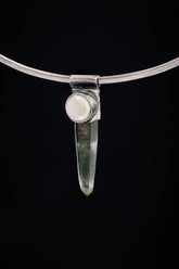 Nepal Inclusion Quartz South Sea Pearl Stack Pendant shown on black background with oxidized sterling silver cap and clear green-toned crystal.