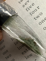 Close-up of Nepal Inclusion Quartz showing green internal mineral inclusions, natural crystal clarity, and oxidized sterling silver setting.