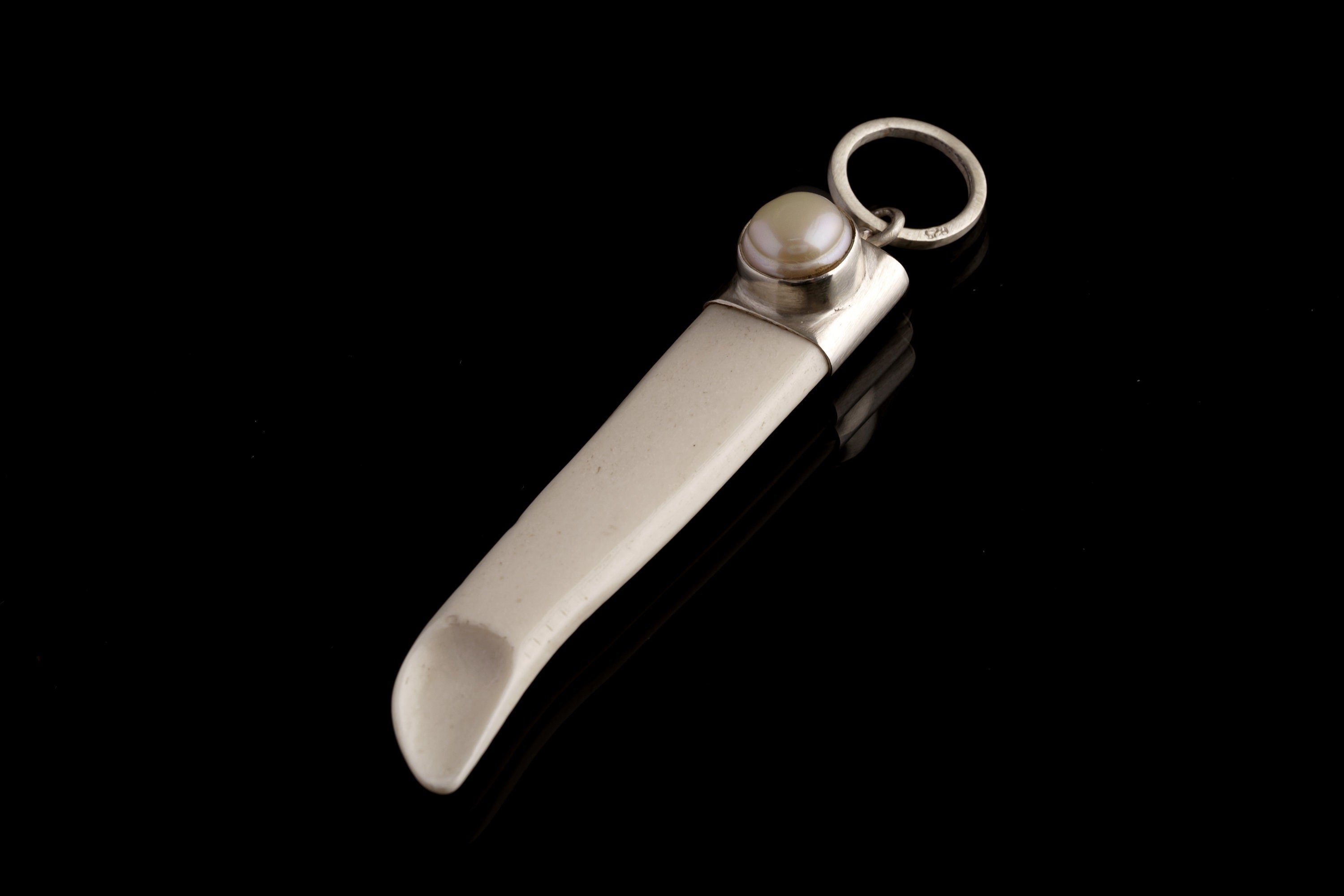 South Sea Pearl Antique Bone Spoon Pendant shown on dark background with sterling silver cap and carved bone scoop.