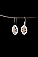 White Lightning Ridge Opal earrings displayed on a silver choker, showing sterling silver hooks and pale Opal dangles.