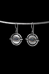 Old World Labradorite Circle single earring in hammered 925 sterling silver shown worn on the ear.
