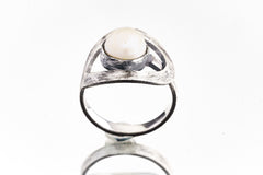 Front view of Pearl adjustable loop ring showing natural Pearl, open-back bezel setting, and textured silver loop design.