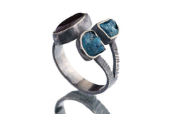 Side view of Apatite Ammolite Ammonite ring showing bezel-set stones, open-back setting, and textured silver band.