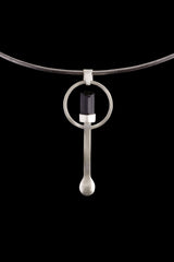 Black Tourmaline hammered spoon pendant displayed on a choker, showing wearable talisman styling and silver spoon shape.