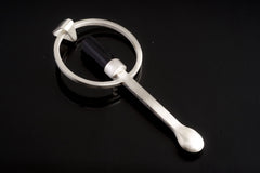 Black Tourmaline sterling silver ritual spoon shown on dark background with hand-brushed silver and dark crystal setting.