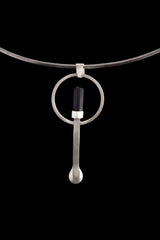 Black Tourmaline silver ritual spoon displayed on a choker, showing wearable talisman styling and spoon form.