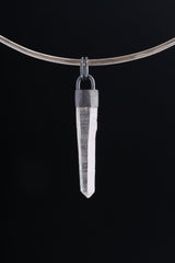 Australian Clear Quartz point pendant shown on black background with oxidized sterling silver cap and thick round coil bail.