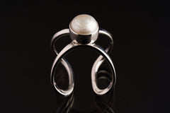 South Sea Pearl Textured Loop Ring shown on black background with textured silver setting and round Pearl focal point.