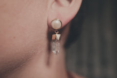 Pearl and Himalayan Quartz earrings shown worn on the ear, with gold-plated settings and clear crystal dangle.
