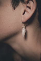 Pearl dangle earrings shown worn on a model, with natural Pearl drops and sterling silver ear fittings.