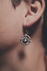 Labradorite Circle Cross earrings shown worn on a model, with sterling silver dangles and symbolic layered design.