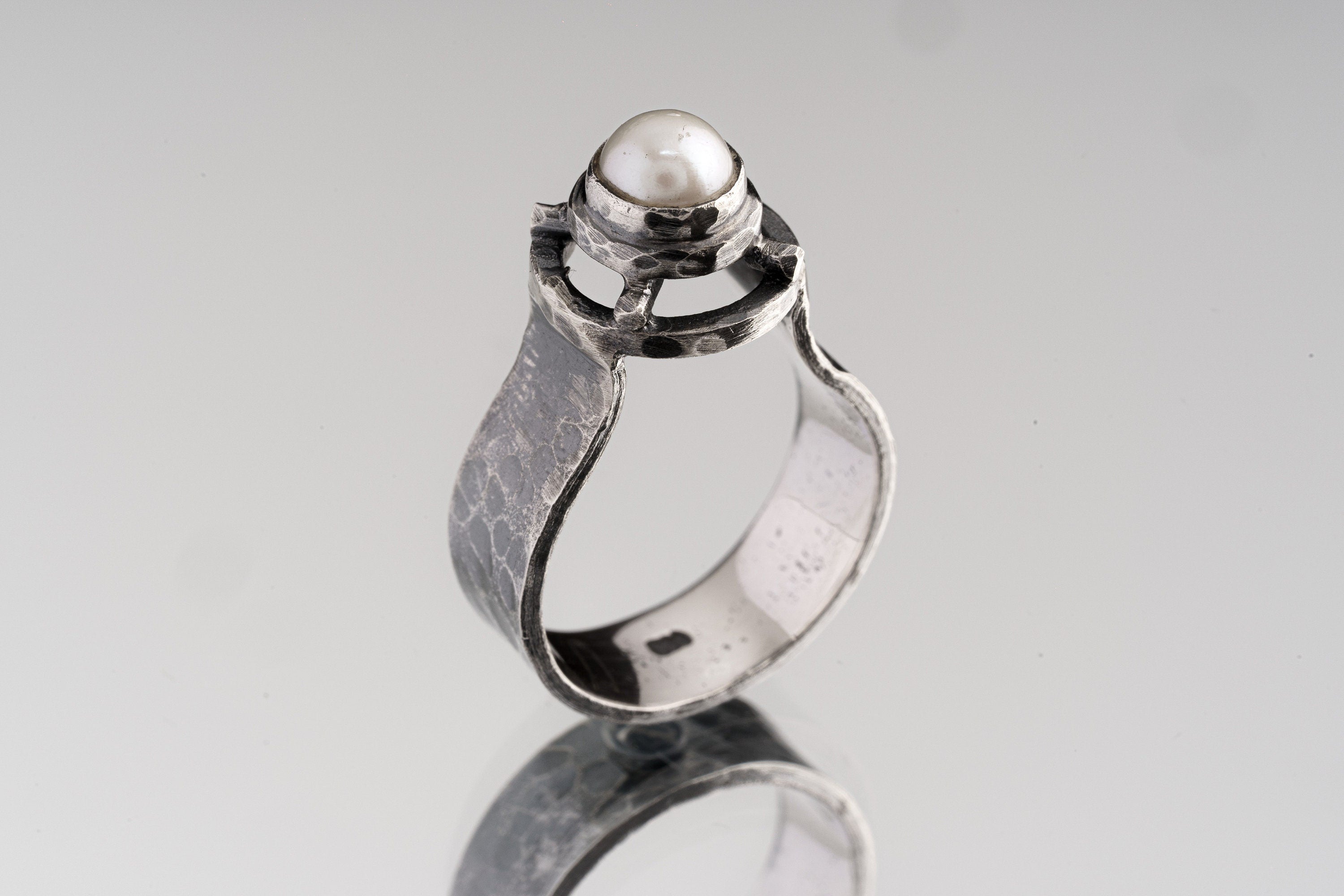 A Grade Basra Pearl Ring shown on white background with oxidized sterling silver texture and natural pearl centre.