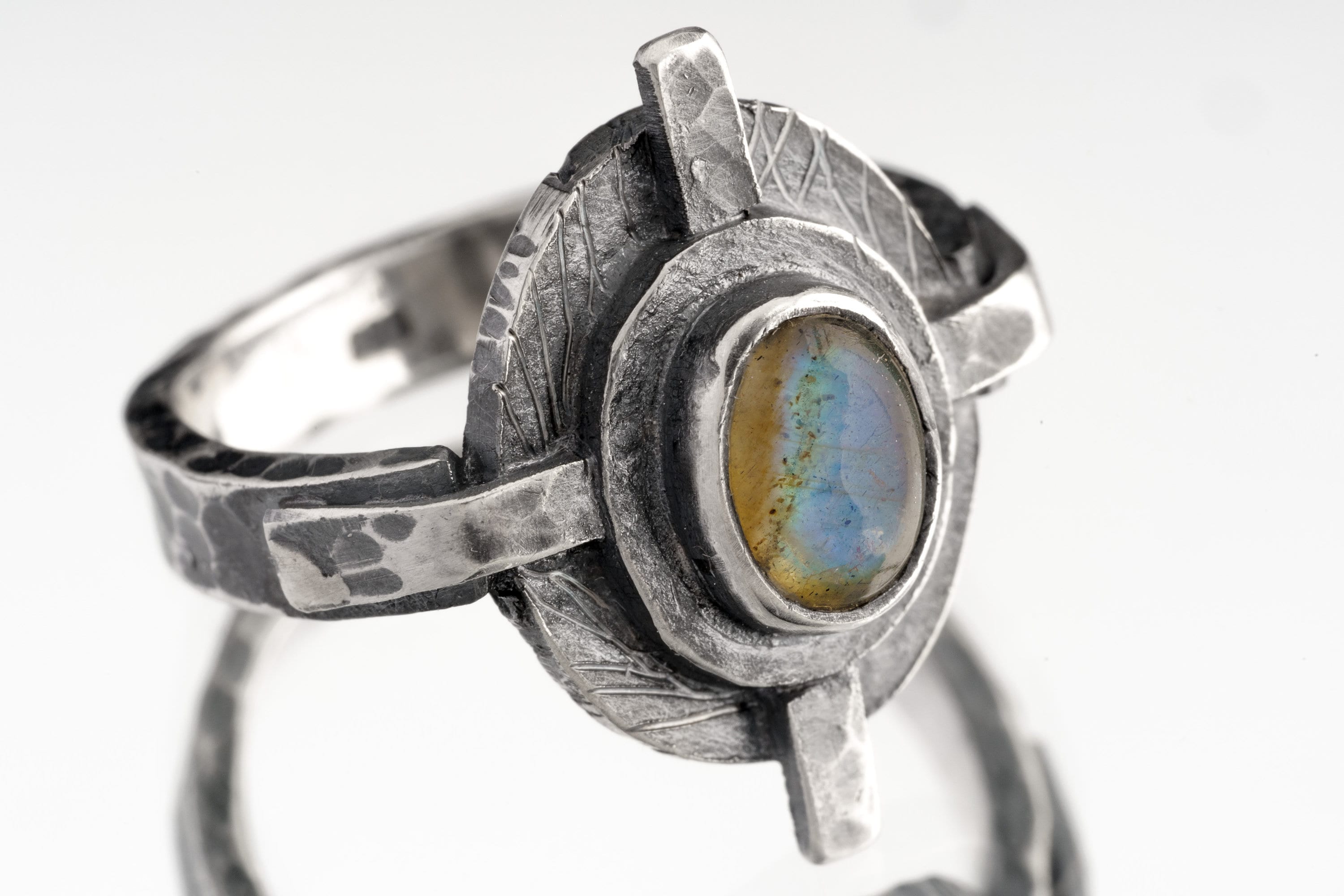 Rainbow Labradorite Compass Ring shown on white background with oxidized sterling silver setting and blue-green gemstone flash.