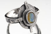 Rainbow Labradorite Compass Ring shown on white background with oxidized sterling silver setting and blue-green gemstone flash.