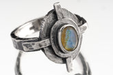 Rainbow Labradorite Compass Ring shown on white background with oxidized sterling silver setting and blue-green gemstone flash.